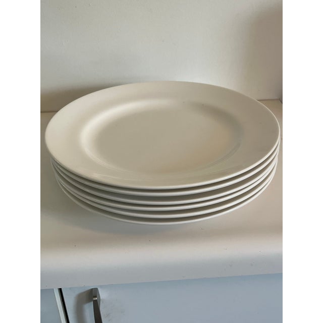 Set of six large white porcelain service or dinner plate plates. Plate stands not included.