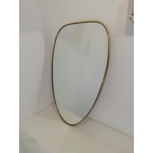 Original 1960s mirror with high quality brass frame. Shield shape ideal for any environment. Excellent condition. Very...