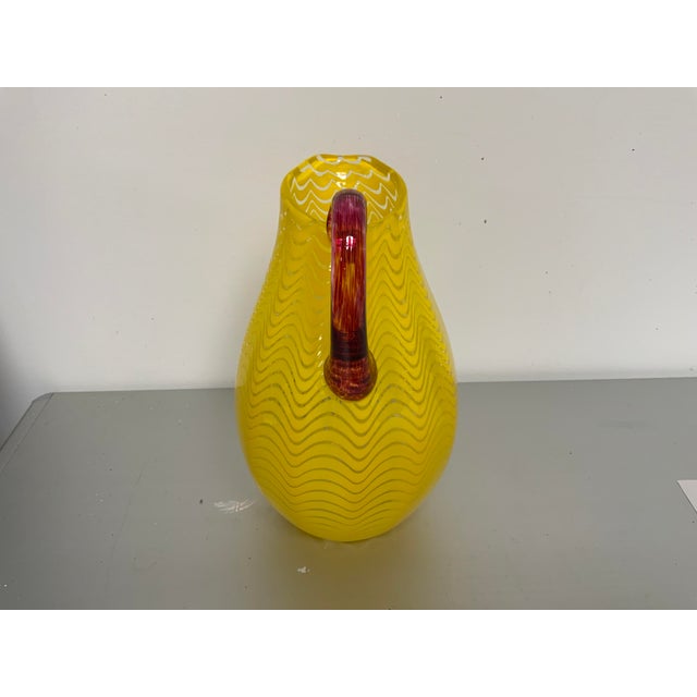 Contemporary Sam Stag Blown Glass pitcher, vivid yellow with maroonish handle. Each of his pieces are unique.