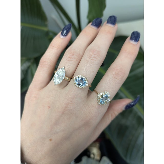 1.5cts Aquamarine Ring with Natural Diamond Accents in solid 14k gold. Features a radiant 9×7mm aquamarine center stone,...