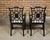 A pair of English Chinese Chippendale style black lacquered armchairs from circa 1950 with upholstered seats. This elegant...