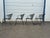 Offered is a Set of 4 Vintage Woodard Style Outdoor Wrought Iron Arm Chairs. These classic patio chairs feature black...