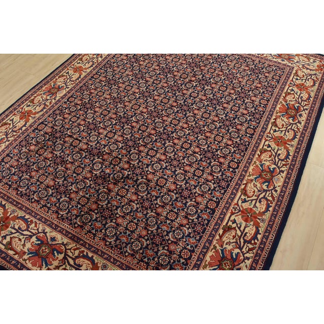 An authentic vintage traditional Sarouk rug hand-knotted with fine wool and natural dyes. This intricately woven rug...