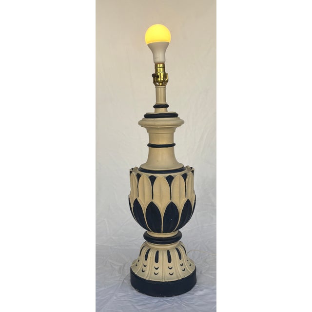 This Mid-Twentieth Century Modern table lamp in the style of The Laurel Lamp Company features a dark blue and creamy white...
