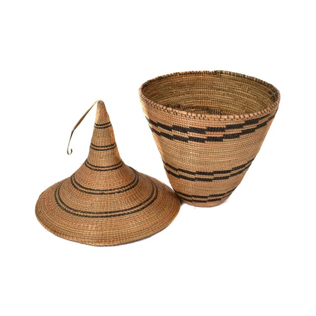 The Tutsi Tight Weave Basket with Lid from Rwanda epitomizes the artistry and tradition of the Tutsi community's weaving...