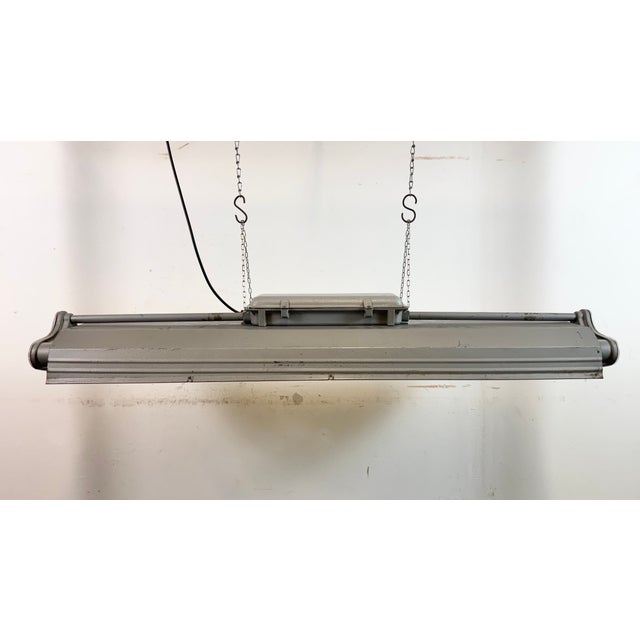This industrial tube light was made by Polam Gdansk in Poland during the 1970s. It features an aluminium body and iron...