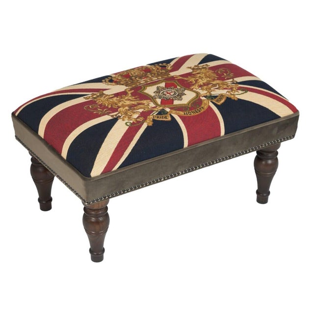 Meticulously handcrafted in the United Kingdom, this upholstered stool boasts classic studding and hand-polished solid...