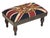 Meticulously handcrafted in the United Kingdom, this upholstered stool boasts classic studding and hand-polished solid...