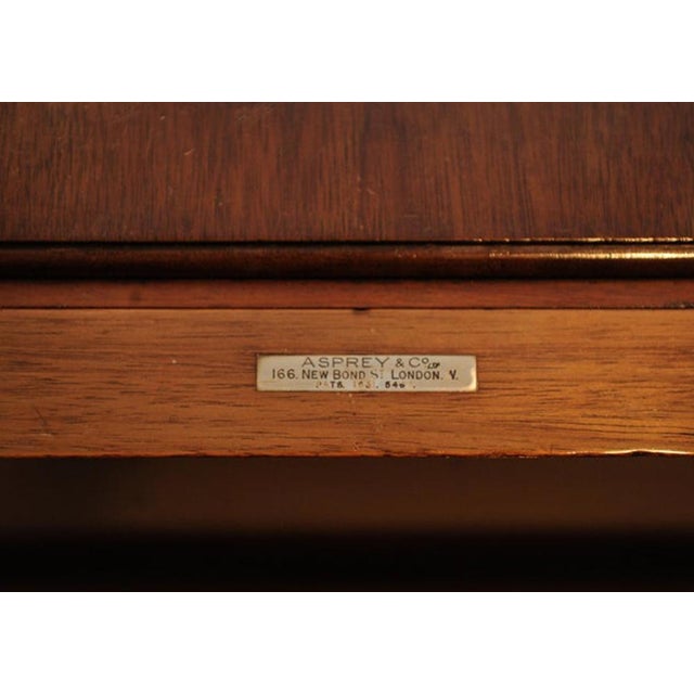 The rectangular and hinged two panel top enclosing an elevating drinks surface which reveals itself when opened from the...