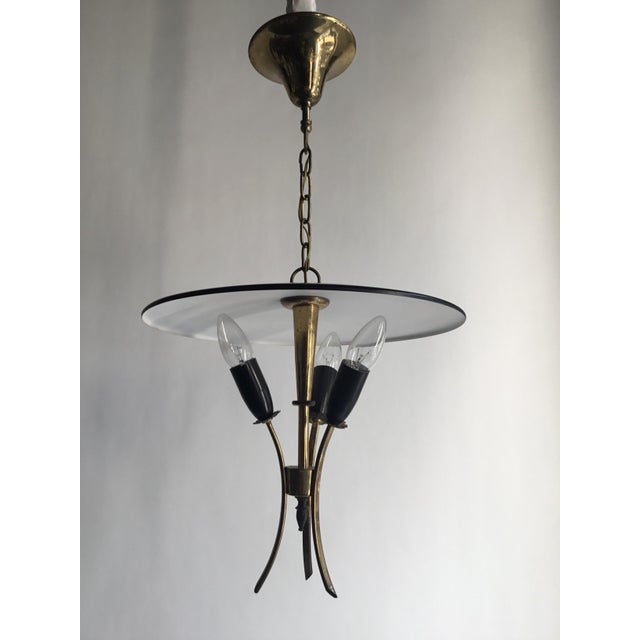 Elegant and authentic Italian Stilnovo lamp from the 1950s, crafted in brass with sections finished in classic black and...