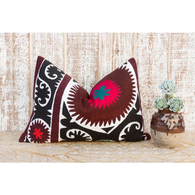 Made from a vintage Suzani tapestry, it features hand done embroidery and a solid linen back. Suzani is a Persian word...