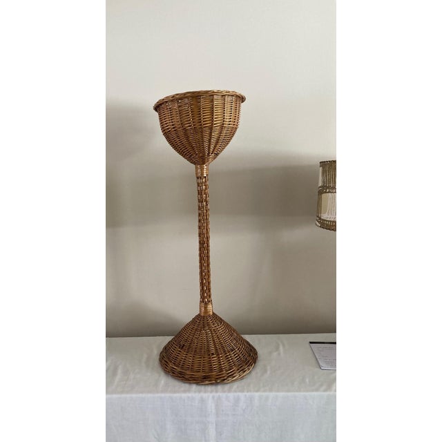 Very nice natural wicker plant stand. Dimensions: 15" diameter base x 38.5" tall Interior diameter (for plant) = 10"