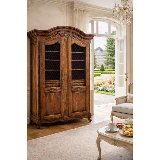 DESCRIPTION: A magnificent example of Guy Chaddock’s celebrated Almont Collection, this grand French Provincial armoire is...