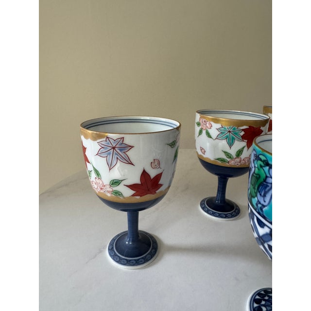 Mid 20th Century Set of 5 Japanese Porcelain Footed Sake Goblets — Hand-Painted, Arita Style — Autumn, Garden & Egyptian Motifs For Sale - Image 4 of 8