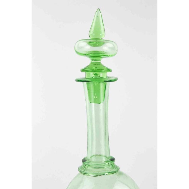 Vintage green glass decanter with cap. Excellent condition.