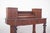 Desk with turned feet. The top has an overlap of small side compartments made up of symmetrical drawers, six in all, as...