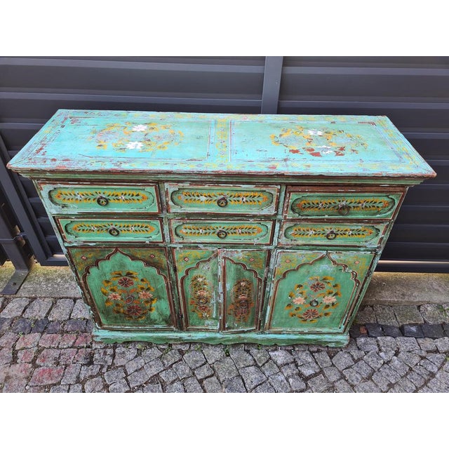 An original, hand-painted chest of drawers from India, made of solid wood. The piece stands out for its decorative...