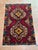 Afghan Balouch rug, hand knotted in Afghanistan from 100% wool. Measuring 2’11” x 4’7”, this vibrant tribal rug features...