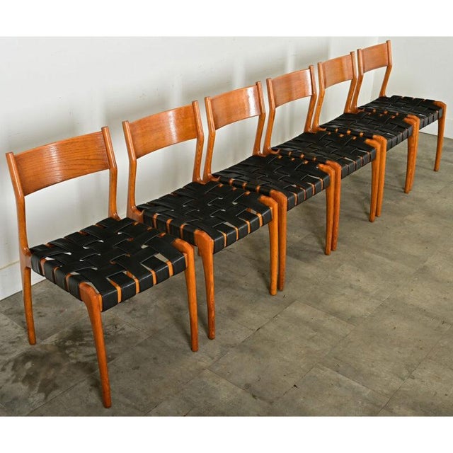 Dimensions: 32 ⅜” H x 17 ½” W x 18 ¾” D A timeless set of six armless dining chairs by the Italian firm Consorzio Sedie...