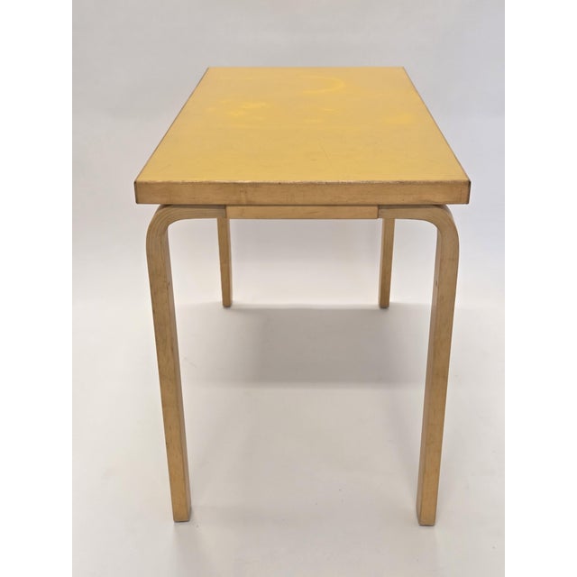 Artek table, birch with yellow linoleum. Designed by Alvar Aalto. The table is from the 1960s and shows nicely signs of...