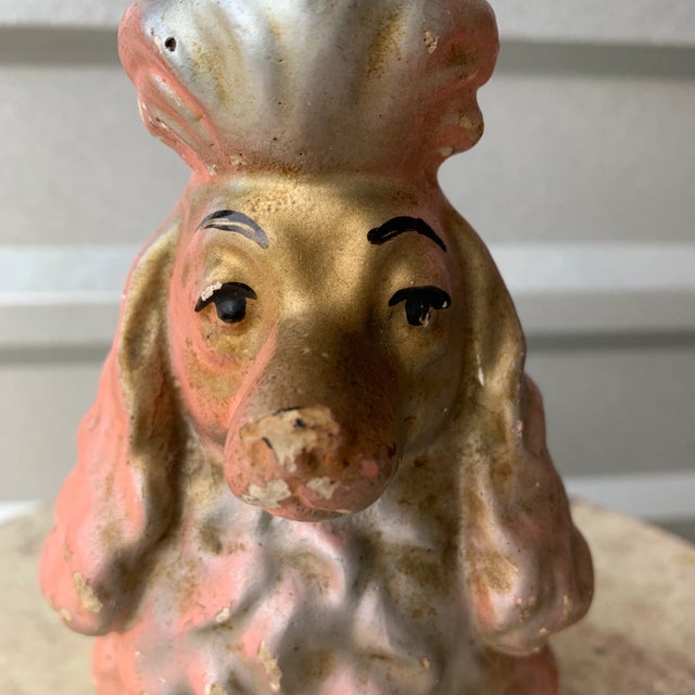 A darling little dog perfect for a shelf. Colors of pink, gold, and silver with hand painted eyes. Is a coin bank but...