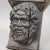 Wooden Sculpture of a Masculine Face A highly detailed antique sculpture of a male face. It is an impressive wall...