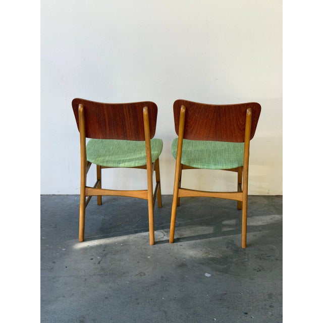 Elegant pair of Danish Modern dining chairs designed by Ib Kofod-Larsen for Christensen & Larsen, produced in Denmark...