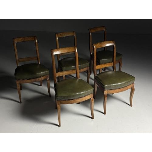 Set of 5 dining chairs Originally from France, early 20th century. The seats are upholstered in green leather. All five...