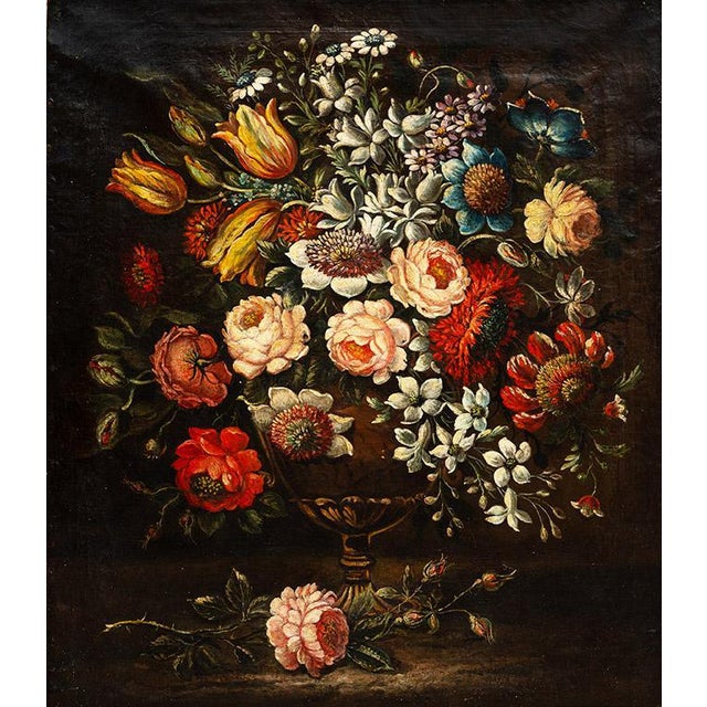 An antique oil painting on canvas with a period gilded wooden frame, depicting a 17th-century still life with flowers. The...