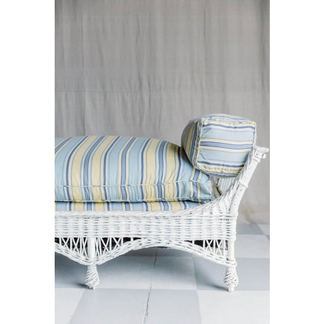 The Mallory Antique White Wicker Daybed invites you to kick back in style with its big, fluffy cushion wrapped in cheerful...