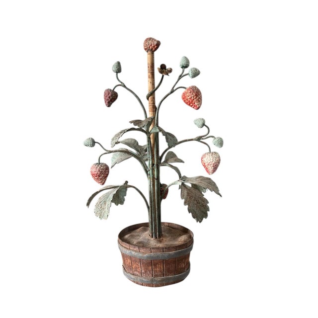 A lovely, pair of vintage Italian tole potted strawberry plants. Each features a leafy tole plant, adorned with red...