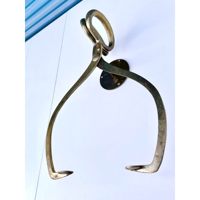 A striking piece of early industrial design, this antique brass ice block holder once served a practical role in cold...