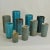 Set of ten studio ceramic cylinder vase of various heights in turquoise tones created by in 3 different glazes. They are...