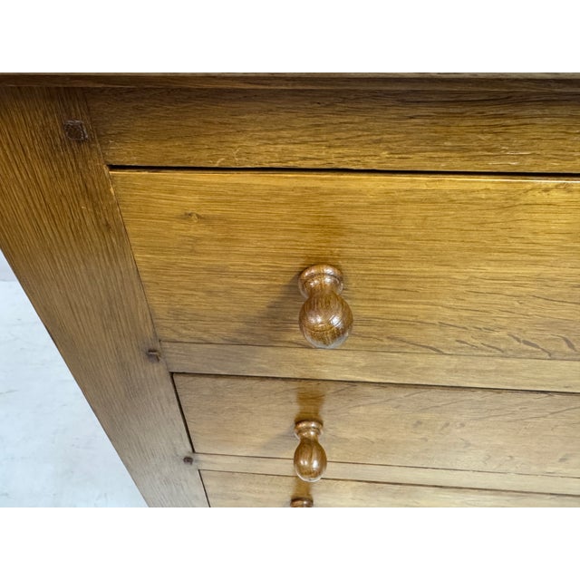 A mid-century Belgian chest of drawers in solid oak, dating to the 1960s, with a focus on honest materials and...