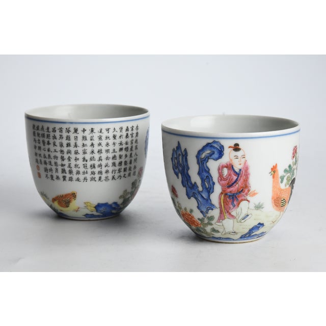 Description - A pair of deep U-shaped cups very finely painted with the scene of Jia Chang stamping his left foot to call...