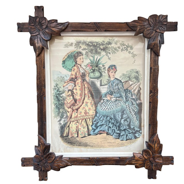 This exquisite pair of 19th-century Victorian fashion engravings is presented in beautifully carved Black Forest–style...