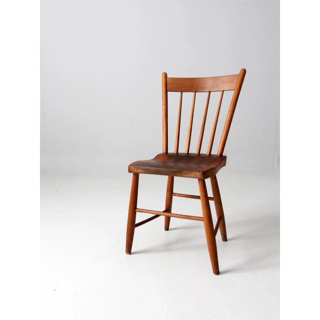 An antique farmhouse chair with a timeless primitive character. This dining or side chair features a solid plank seat and...