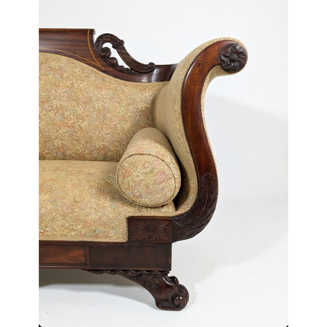 Elevate your parlor or living space with this exquisite antique American Empire settee, a timeless piece that blends...
