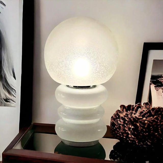 Elegant and rare Glass Base Table Lamp in Murano glass, an exquisite piece Mazzega style. This sophisticated table lamp is...