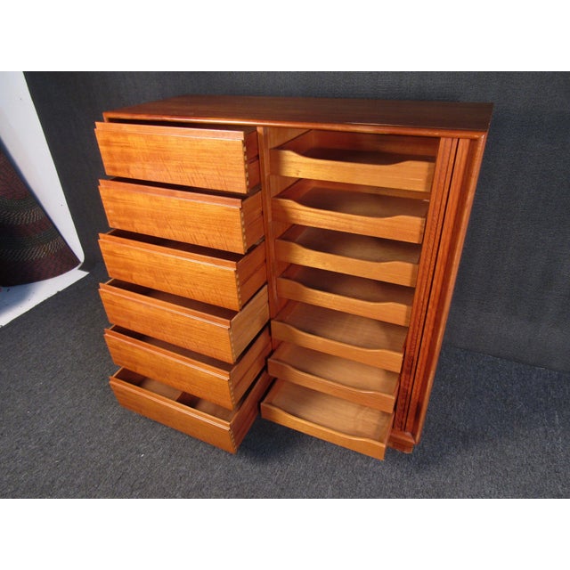 This Mid-Century Modern cabinet offers generous storage and organization with its many drawers and roomy compartments....