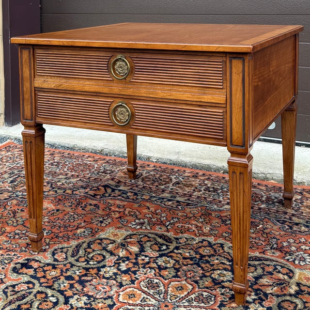 A vintage 20th century Henredon Fine Furniture French Louis XVI golden walnut side table featuring a square banded top...