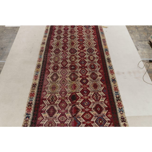 Connoting the celebrated tribal style, this 6x13 kilim rug hails from a special new curation of mid century flat weaves....