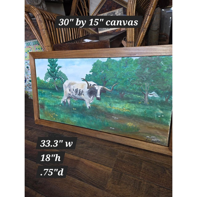 Charming vintage Texas Longhorn Cow painting with lots of greenery in the background. This is signed Avon Curtis.