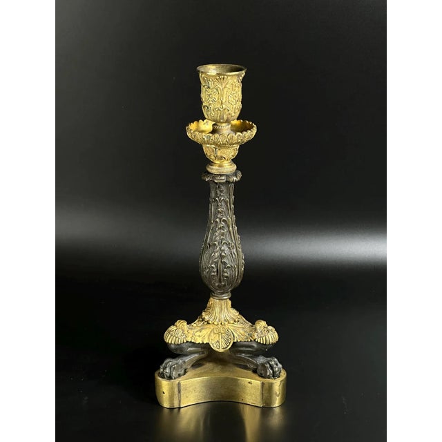 A magnificent French Empire candlestick, dating circa 1810–1820, expertly cast in finely chased bronze with original fire-...