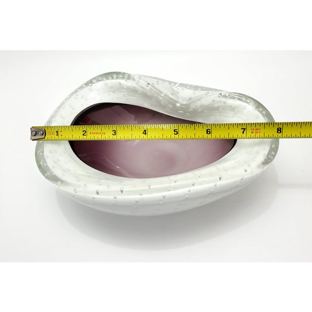 Offering an elegant Murano glass bowl, Italy, circa 1950s. Partial foil label is still intact on bottom of bowl. The color...