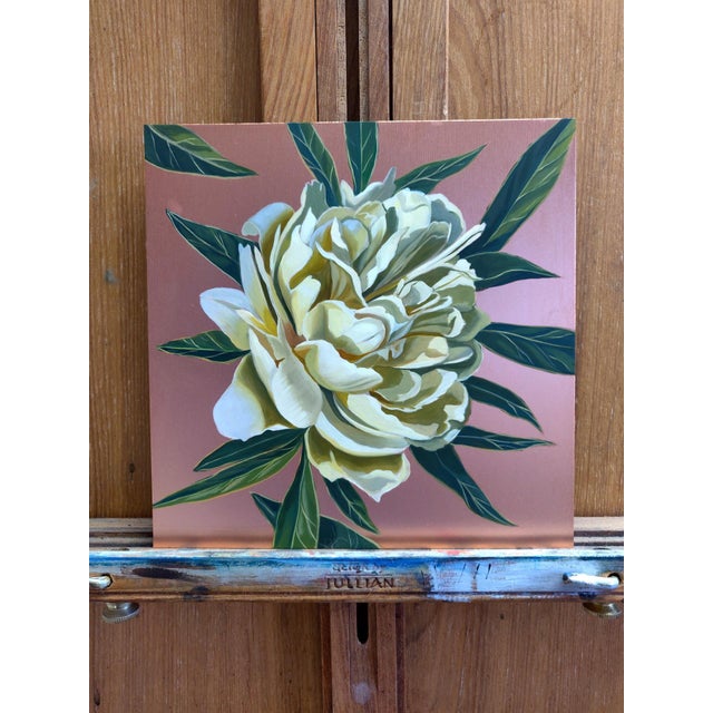 This artwork depicts a lush, blooming flower in soft cream tones, surrounded by vibrant green leaves against a rich copper...
