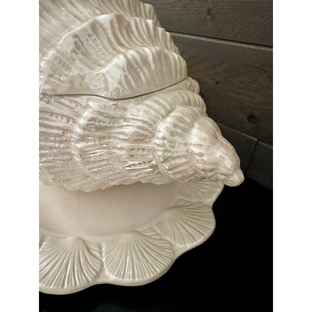 Gorgeous iridescent finish. Oozing with coastal charm, this ceramic shell tureen set features a large lidded conch shell...