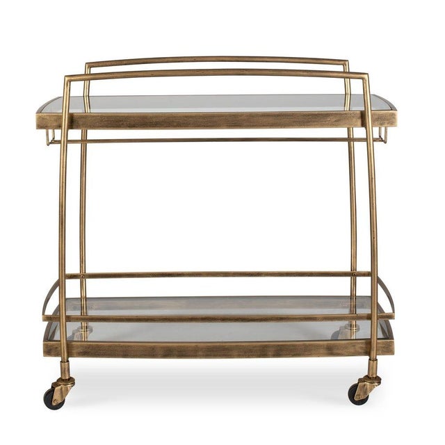 Entertain in style with the Scarritt Bar Cart. A sleek, antique brass finished iron frame supports two spacious glass...