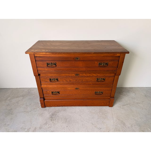 Classic American Traditional three-drawer showcasing beautiful natural wood, clean lines, and original brass hardware. Its...