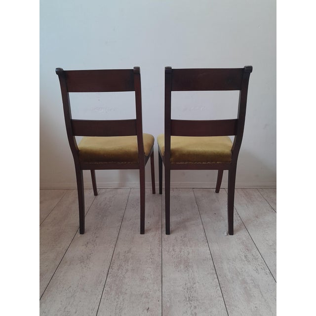 The two mahogany chairs have slanted horizontal beams in the back, veneered with flower mahogany. These chairs with curved...